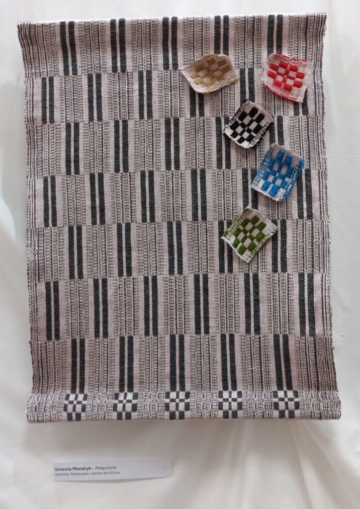 Tkanina wykonana techniką radziuszki. Osnowa bawełna różowa z wiskozą, wątek wełna merino i przędza mieszana. Wykonała Urszula Mendryk
